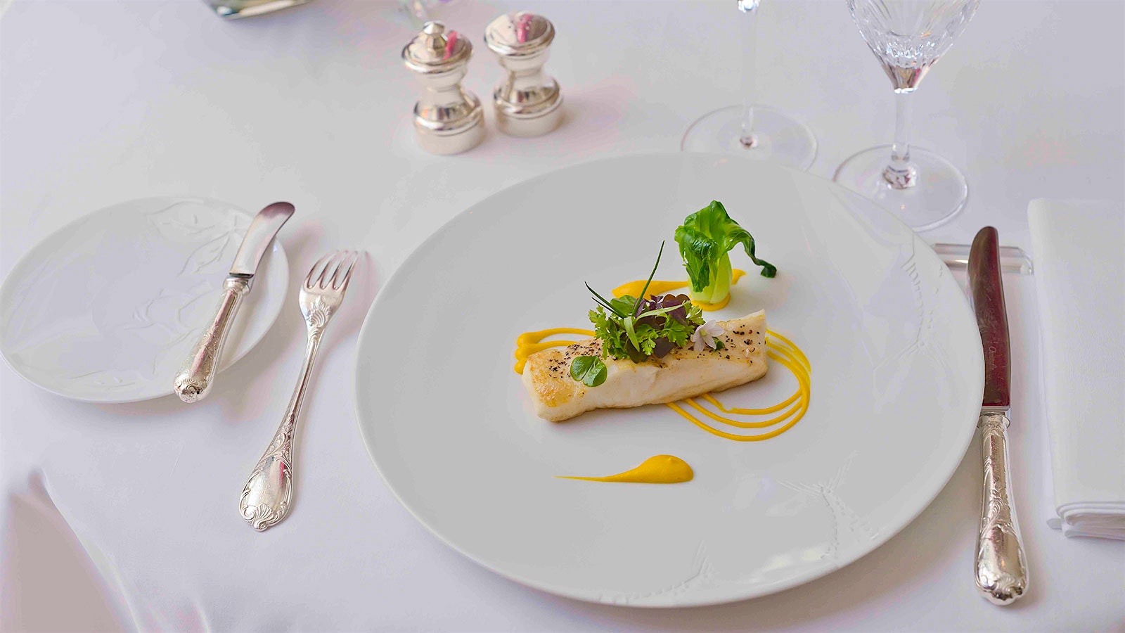 Plate of turbot with beurre meunière with a glass of white wine at Epicure in Paris